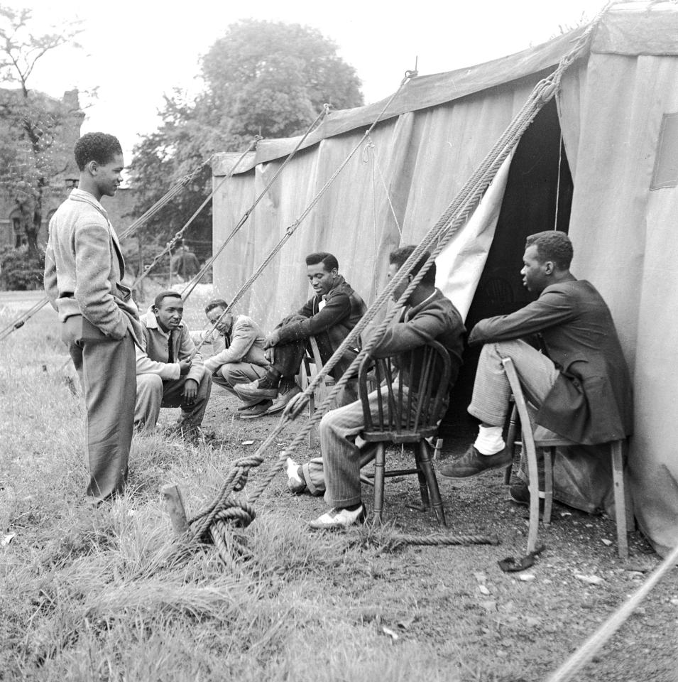  A group wait outside for interviews with immigration officials in Britain in July 1948
