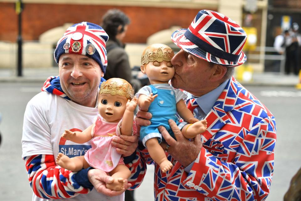 Royal fans John Loughrey, left, and Terry Hutt, right, wait excitedly outside the hospital this morning