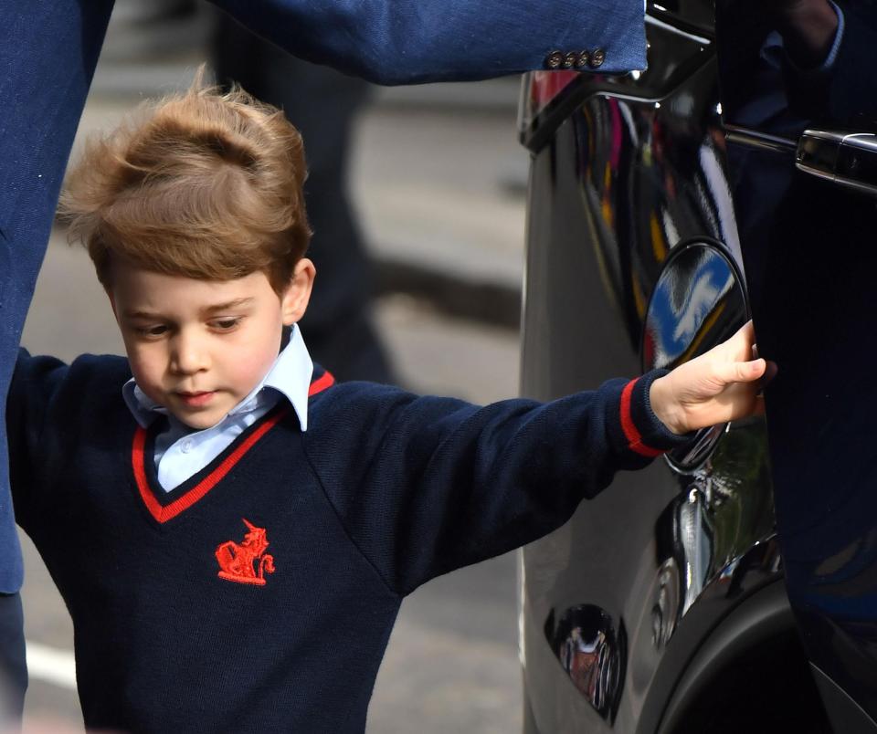 Prince George seen holding onto the car door before the short walk to the hospital