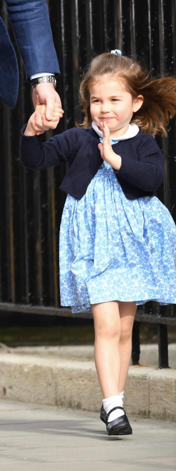 She waves to photographers moments before meeting her younger brother for the first time