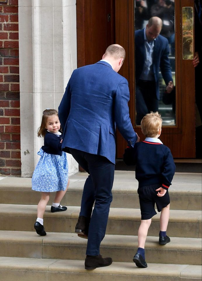 The two-year-old turns her head towards the cameras as she prepares to enter the maternity ward