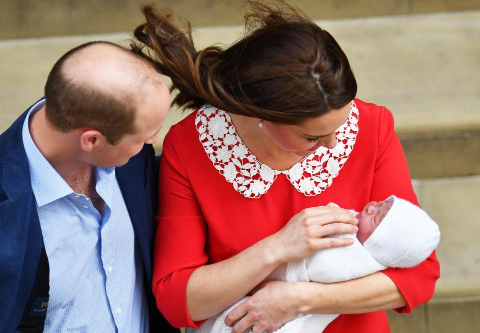 Prince William and Kate look down at their healthy tot on the steps of the hospital