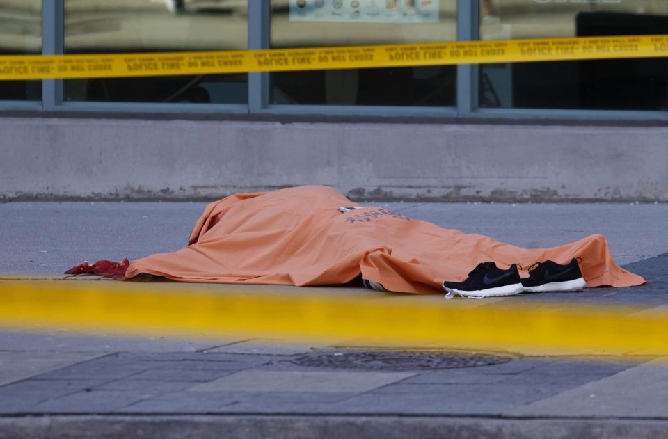 A body lies covered after being hit by the speeding van