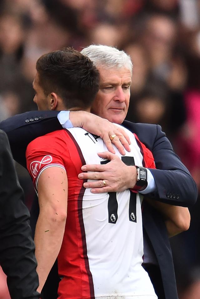 Southampton manager Mark Hughes hugs his two-goal scorer today after three points were secured