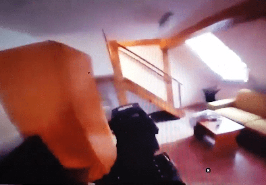 GoPro-style footage shows the armed officers with weapons drawn enter the flat