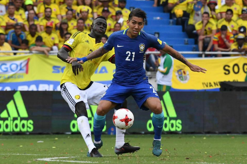 Davinson Sanchez, seen here tackling Firmino, will be vital to Colombia's chances of progressing past the quarters