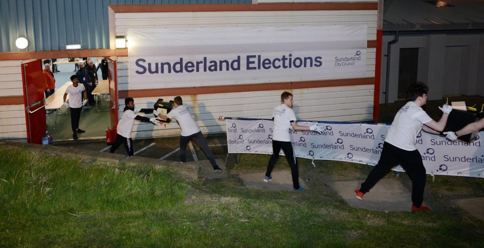 A human chain of counters pass ballots between each other in Sunderland