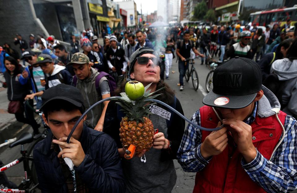  The men smoke marijuana through a pineapple in Bogota, Colombia