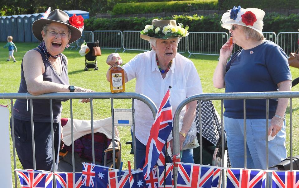 Royal fans install themselves on the Long Walk at a vantage point to view the carriage procession