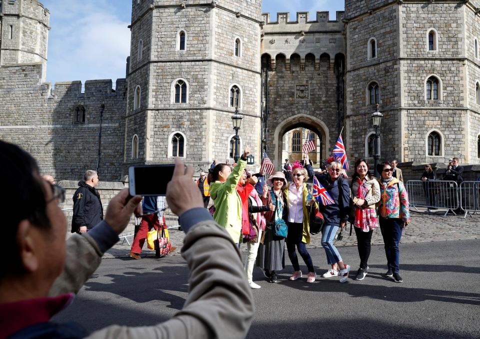 Fans of Prince Harry and Meghan Markle pose outside Windsor Castle