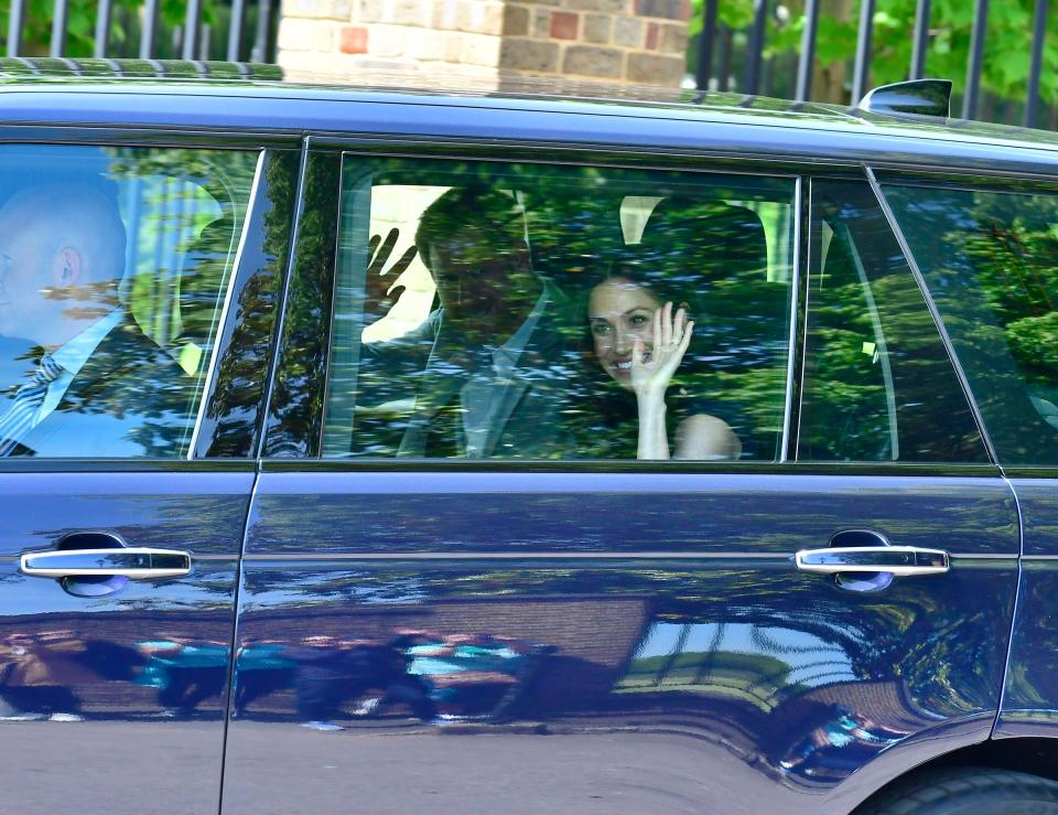 The couple beam as they are driven away from Kensington Palace