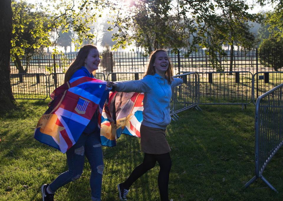 An eager royal fan holds up flags, keen for the ceremony to begin
