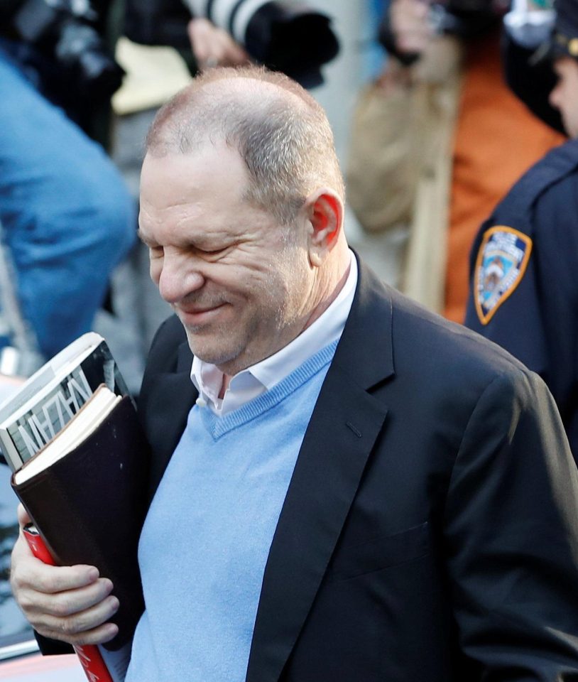 Weinstein carried three books with him as he ran the media gauntlet towards the police station door 