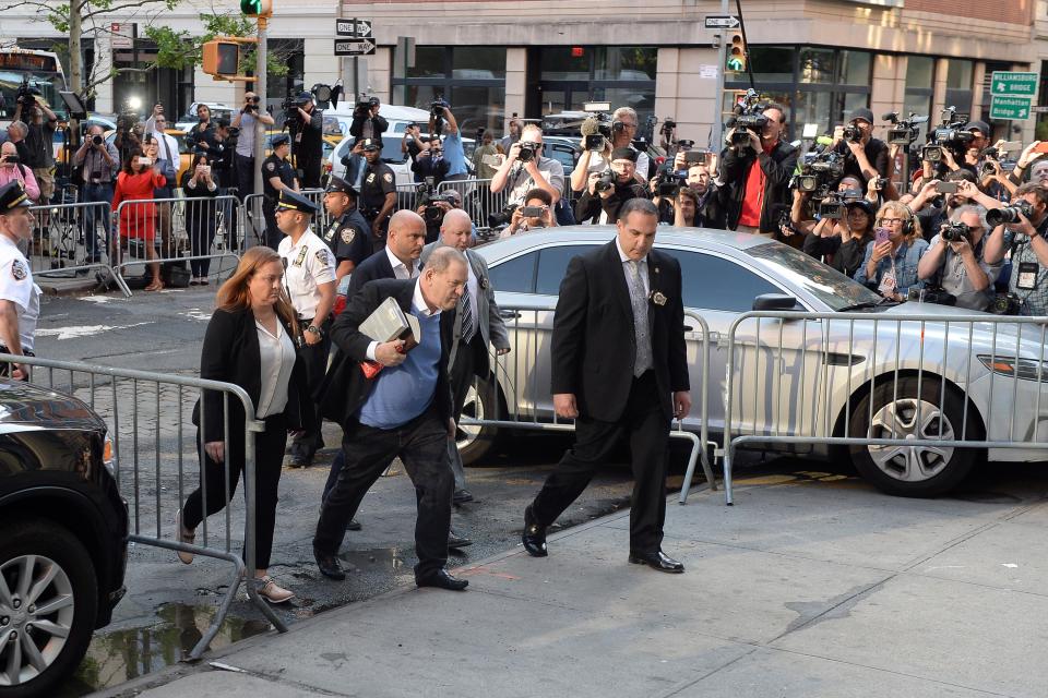 Dozens of reporters and TV crews lined the streets outside the Manhattan police station to watch as Weinstein entered