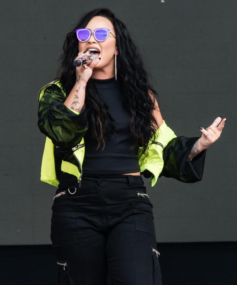 Demi Lovato was a bit more covered up in combat trousers and a neon tracksuit jacket