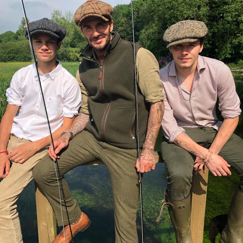 The ex-footballer, centre, with sons Romeo, left, and Brooklyn, right