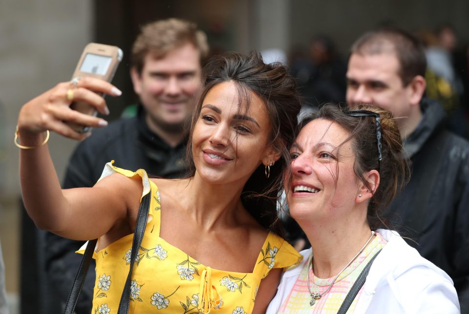 Keegan posing for a selfie with a fan outside of the BBC