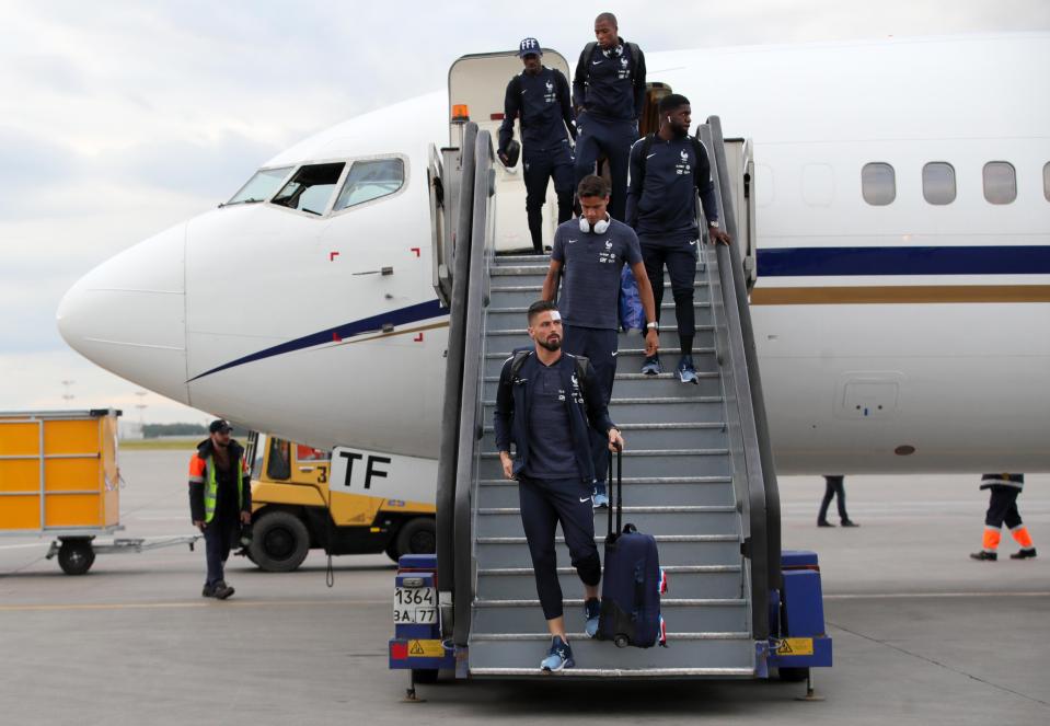  The Chelsea striker steps off the plane after landing in Russia