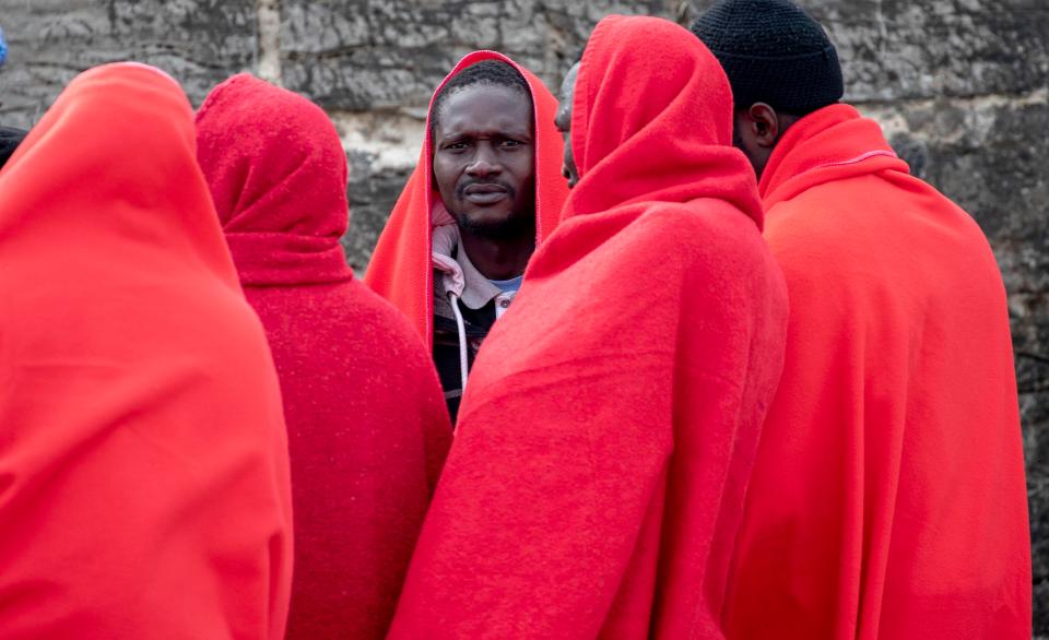  Migrants from sub-Saharan Africa wait on the quayside in the port of Tarifa to be processed after attempting the perilous crossing from Morocco