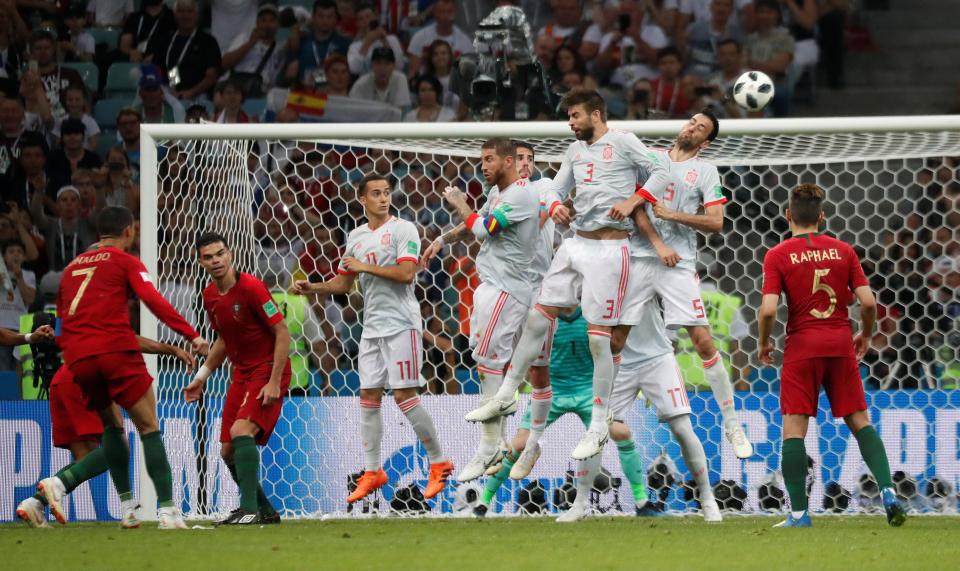 Cristiano Ronaldo gets his effort up and over the wall and into the back of the net
