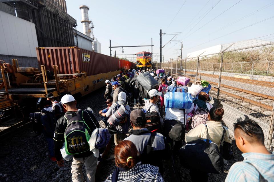  Central American migrants, moving in a caravan through Mexico, walk on the rail line to stop and try to get on a freight train in Tultitlan, in Mexico state