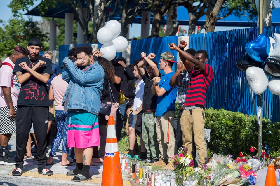  People stood in solitary at the scene where he was killed and made an X with their arms