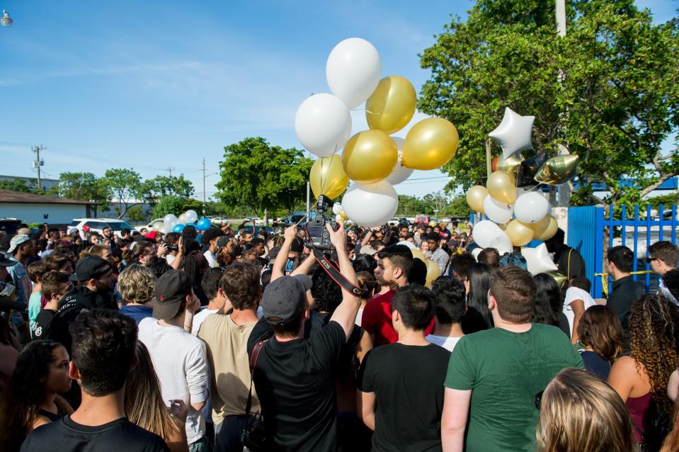  Many brought balloons to the site in Miami, Florida, where the 20-year-old was gunned down