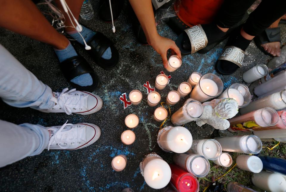  Mourners held a candlelit vigil on the street where their icon was brutally slain by attempted robbers, cops say