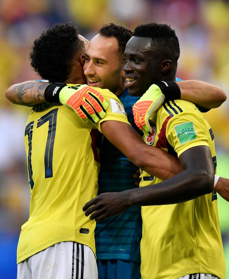  Ospina celebrates with teammates Johan Mojica and Davinson Sanchez after Colombia's win over Senegal