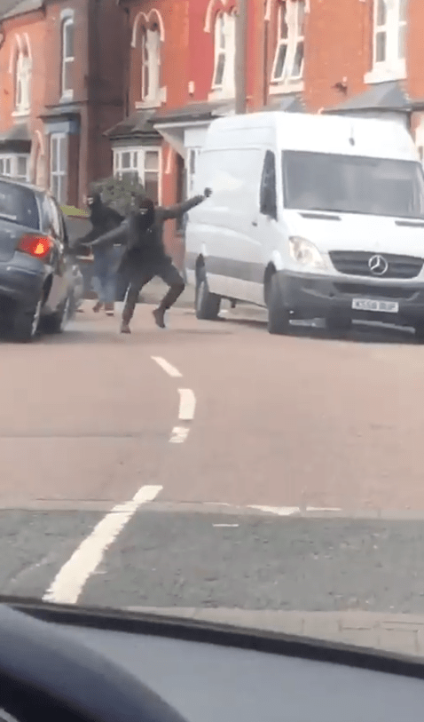  Another balaclava-clad man then exited the BMW and attacked the Toyota with a hammer