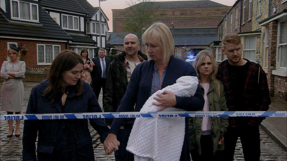 Eileen Grimshaw held hands with Anna as the shocked residents watched the body being taken away 