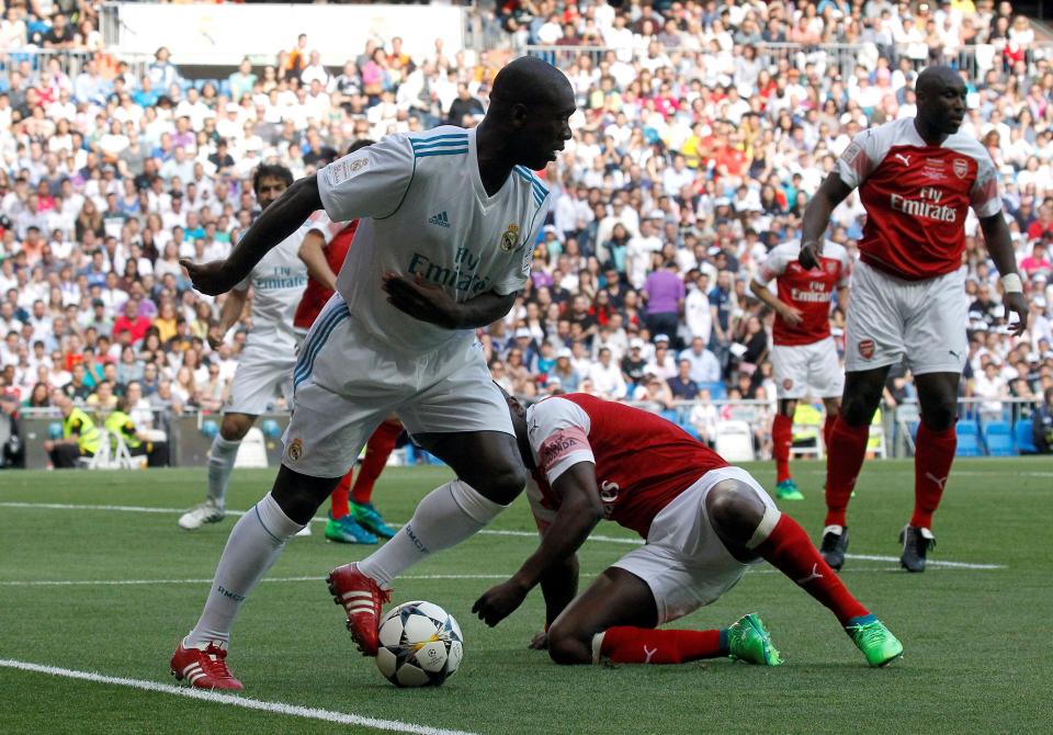  Clarence Seedorf keeps control of the ball and avoids a challenge