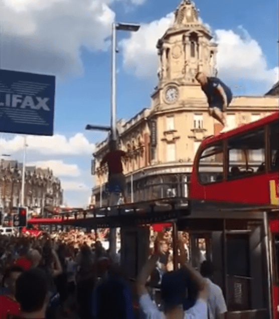  An over-excited England fan climbed onto the top of the double-decker and decided to jump off