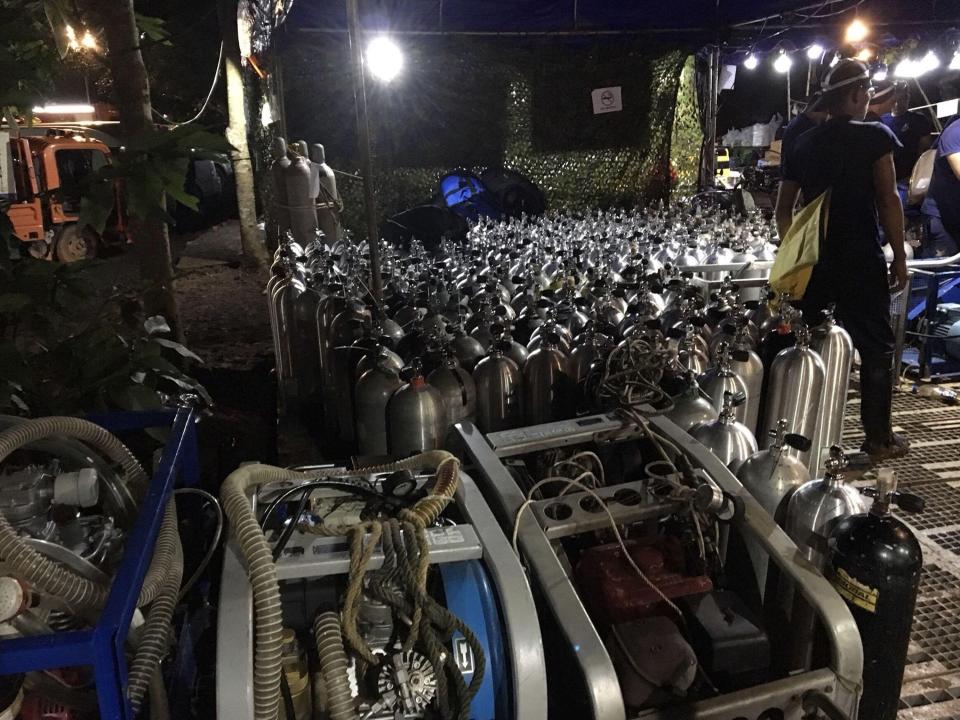 Oxygen tanks are prepared for rescue divers near the entrance of Tham Luang cave 