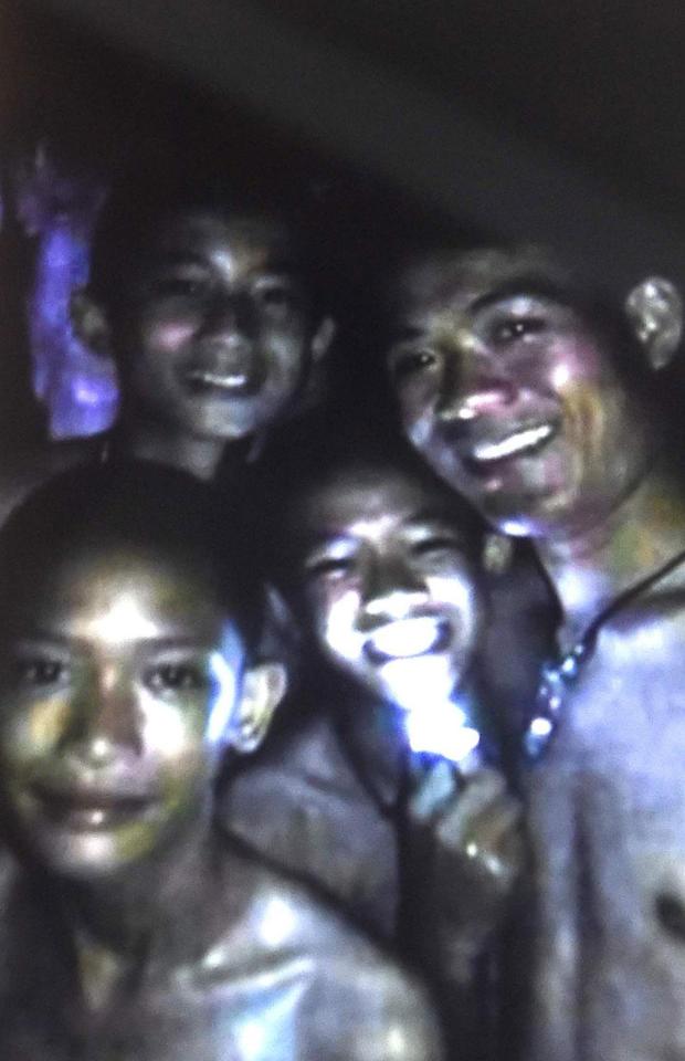 An image shows the boys alive and well after a frantic subterranean search involving experts from across the globe