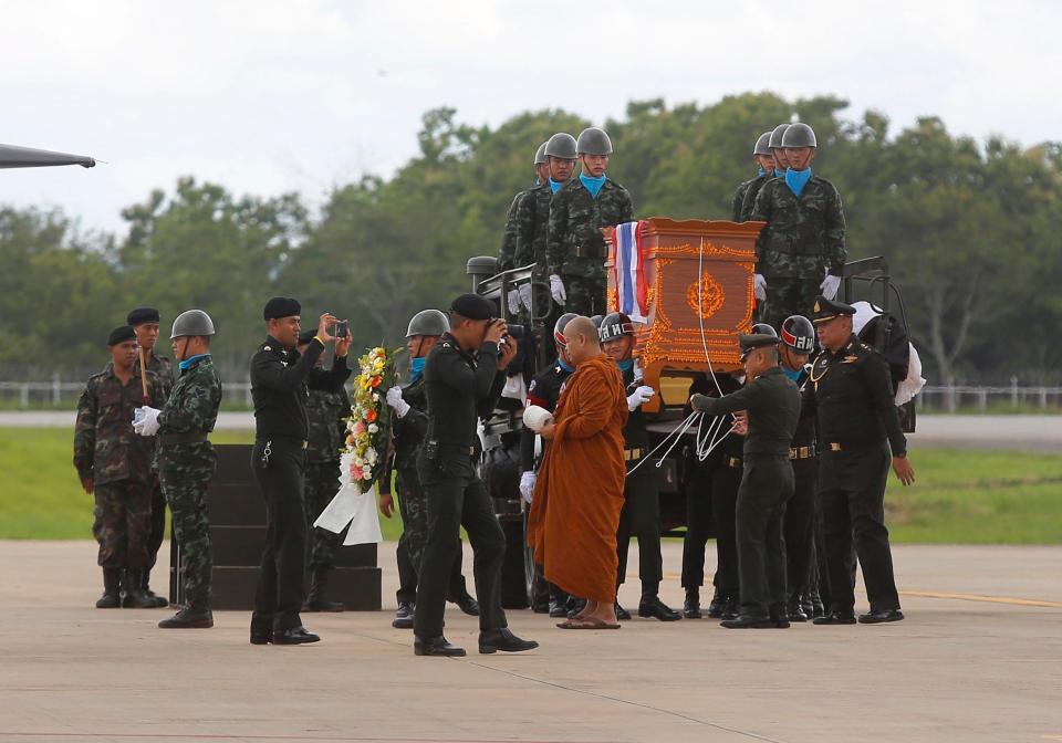 The body of Saman Gunan, a former Thai navy SEAL who died attempting to help the trapped team, is carried during a repatriation and religious rites ceremony at Chiang Rai Airport