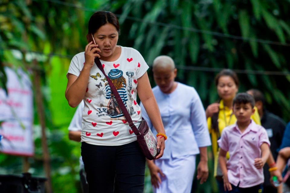  A worried relative of one of the boys speaks on the phone today