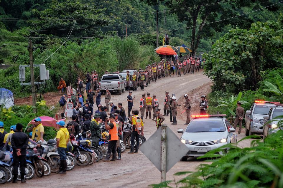  Medical teams wait anxiously outside the caves to help the stricken young boys