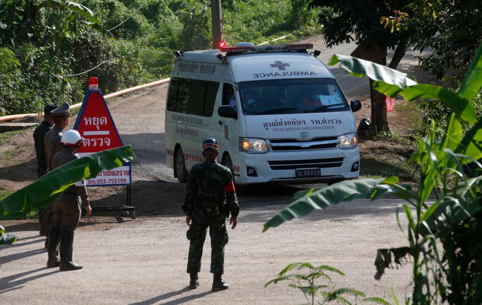 An ambulance with flashing lights speeds one of the lads from the cave today