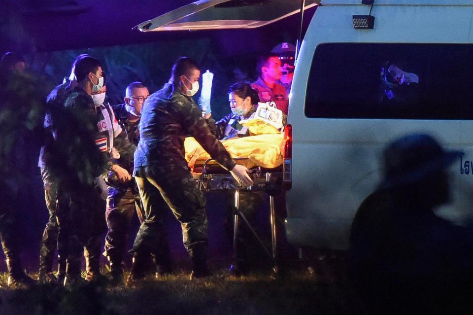 One of the boys to be rescued today is taken from an ambulance to a waiting chopper 