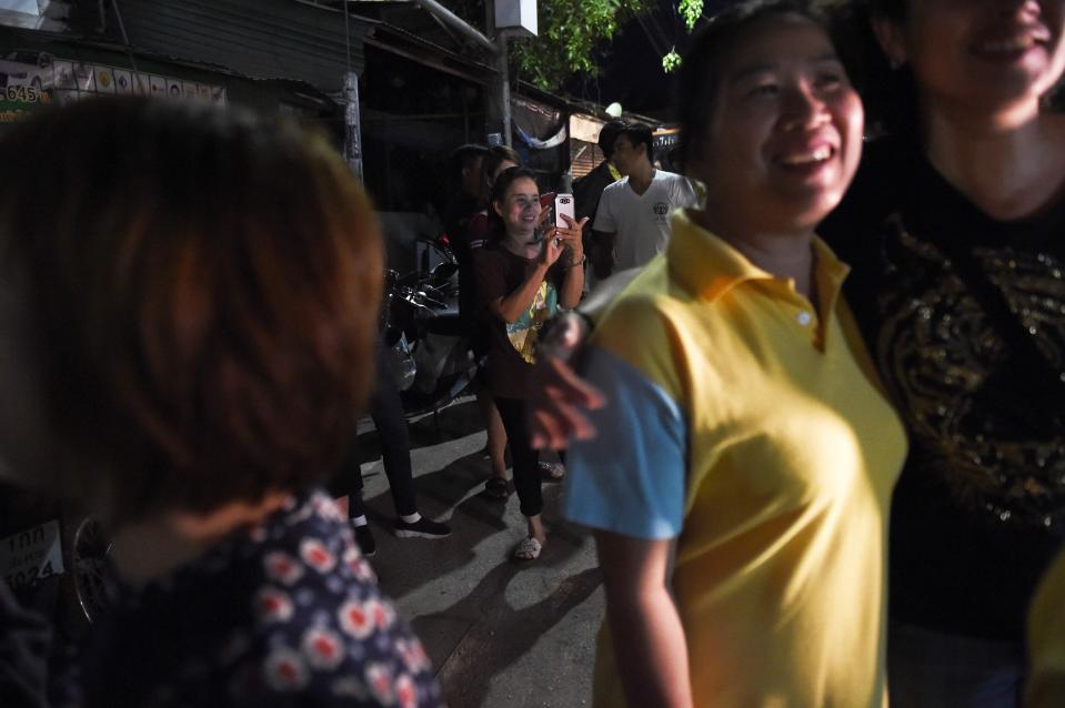 People in northern Thailand hug each other as the country celebrates the rescue of the stricken children