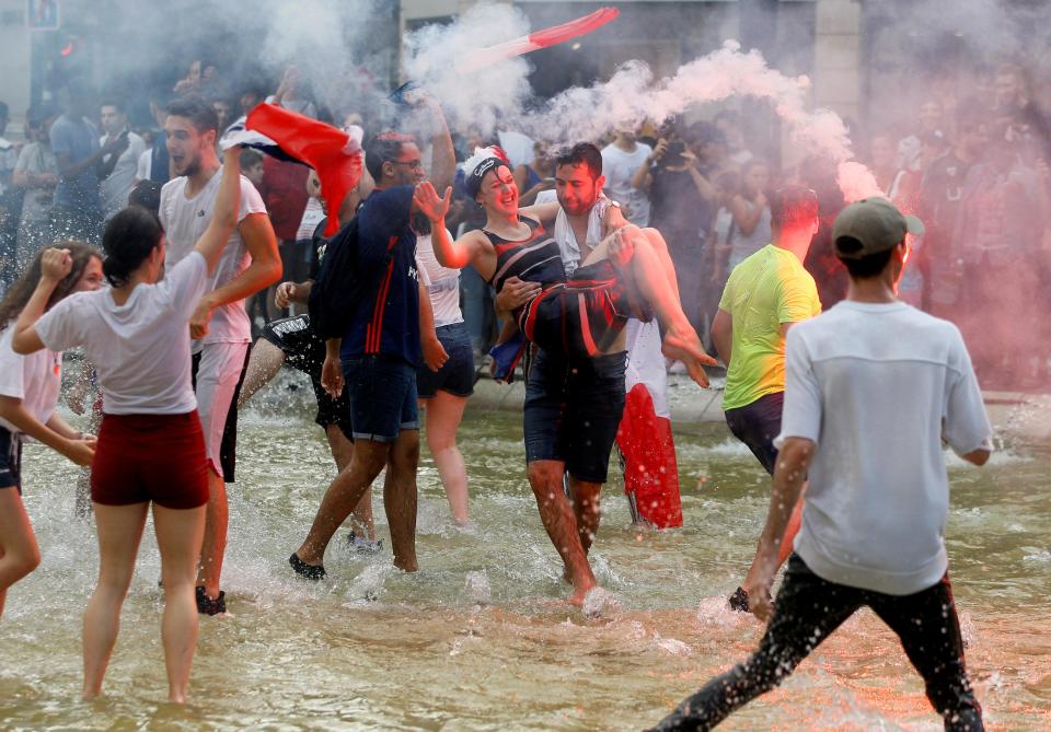 France supporters in Lyon celebrate their World Cup triumph in fountains