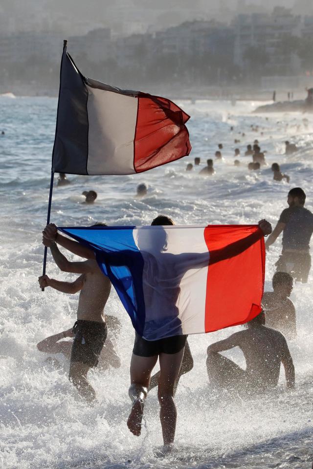France fans celebrate on the beach after winning the World Cup