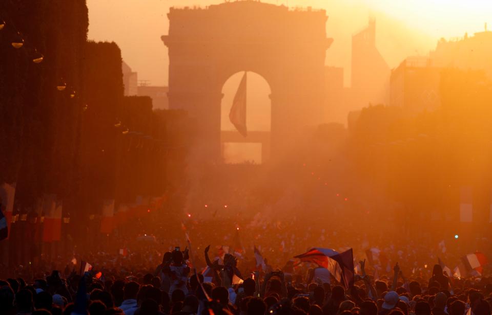 The sun sets on Paris as France supporters party into the night