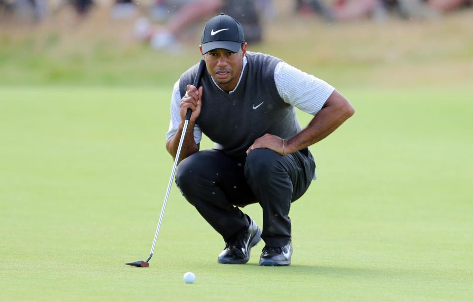  Tiger Woods studies a putt during his third round five-under 66