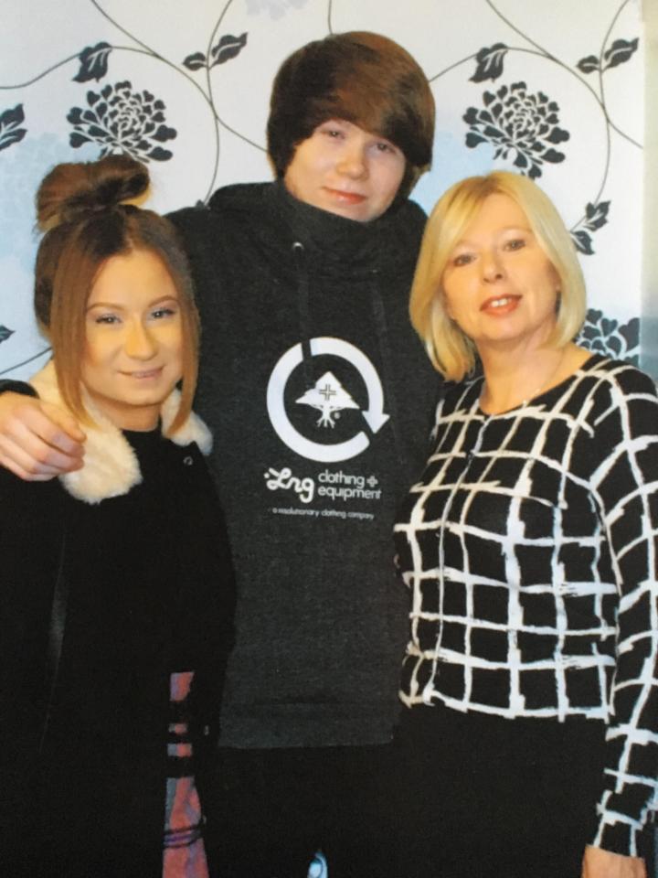  Tom, centre, pictured with his sister Katie and mum Siobhan was 'egged on' to climb into the train