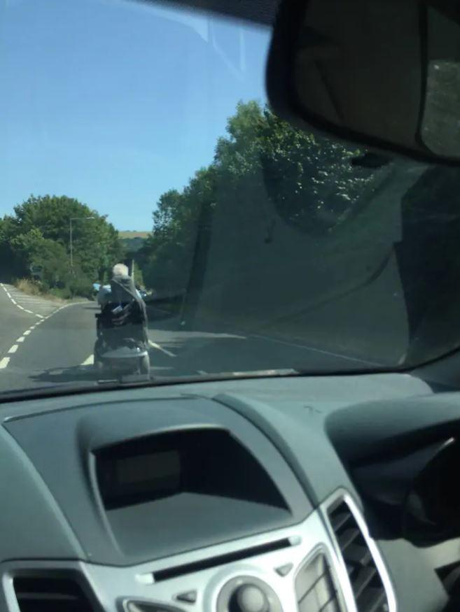  This very patient driver was stuck behind a mobility scooter