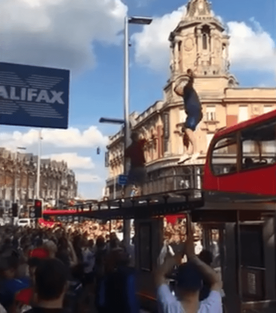 Leap of faith... he jumps from the top of the bus while the crowd cheers on