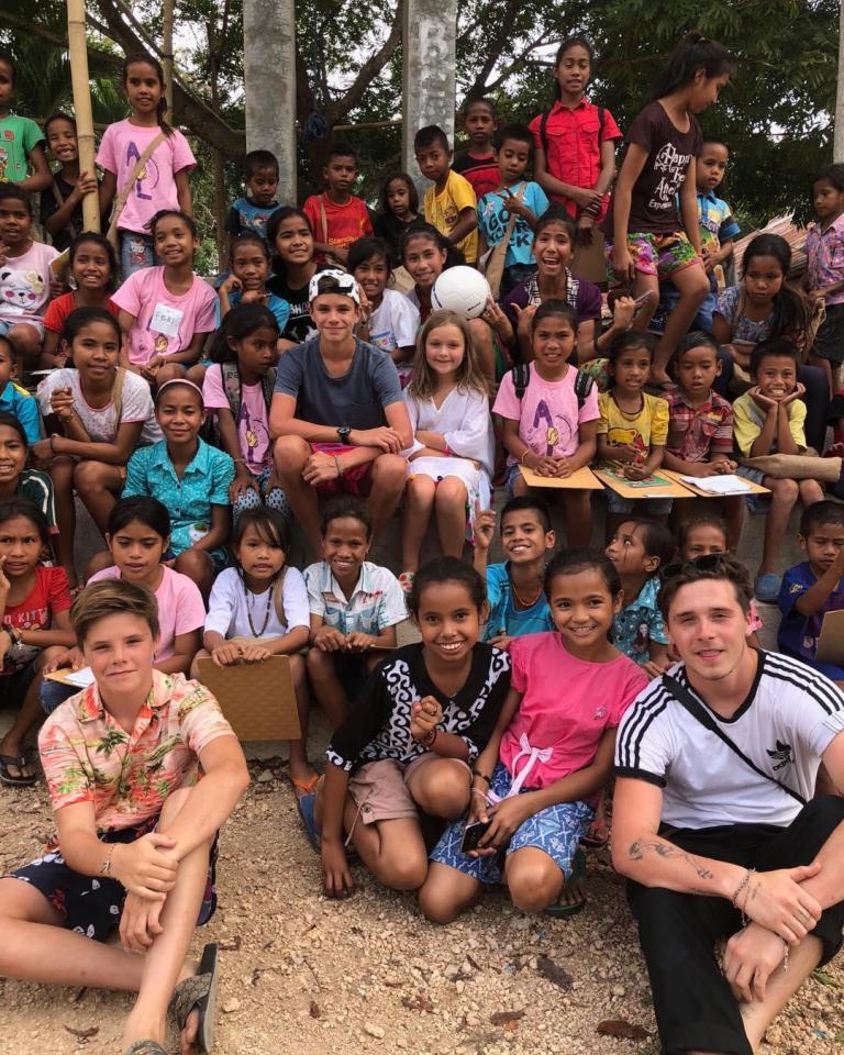  Cruz Beckham and big brother Brooklyn played with the local children