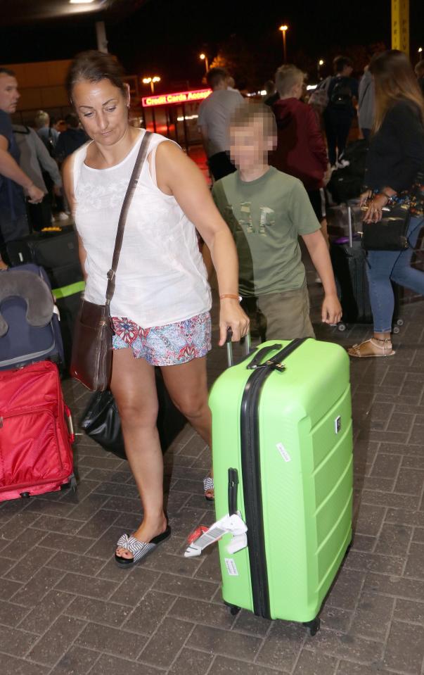  Holidaymakers return to Manchester Airport today after cutting short their trips